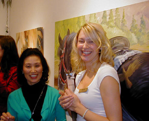 Artist: Gallery Event Photos, Title: Gallery Asst. Carrie, tells Masami Olsen that she has a horse just like the one behind them. - click for larger image