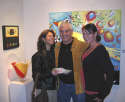 Gallery Event Photos - Collectors, JoAnne and Doug pose happily with their new painting and Ms. Tomassi