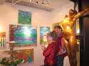 Gallery Event Photos - Kathleen Hooks viewing some of Bill Braun's artwork...talk about two opposite painting styles