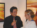 Gallery Event Photos - Liang Wei with Lemon Drop in hand talks to fellow gallery artist Diane Culhane